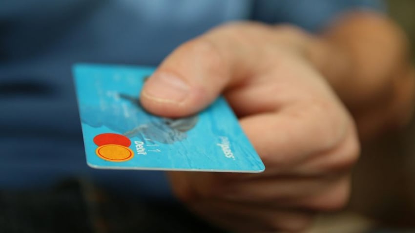 A man paying by blue credit card