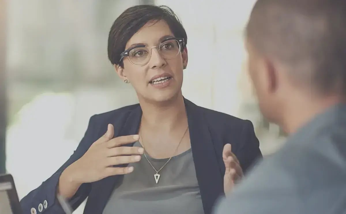 A professional with their client discussions foreign exchange investment options.