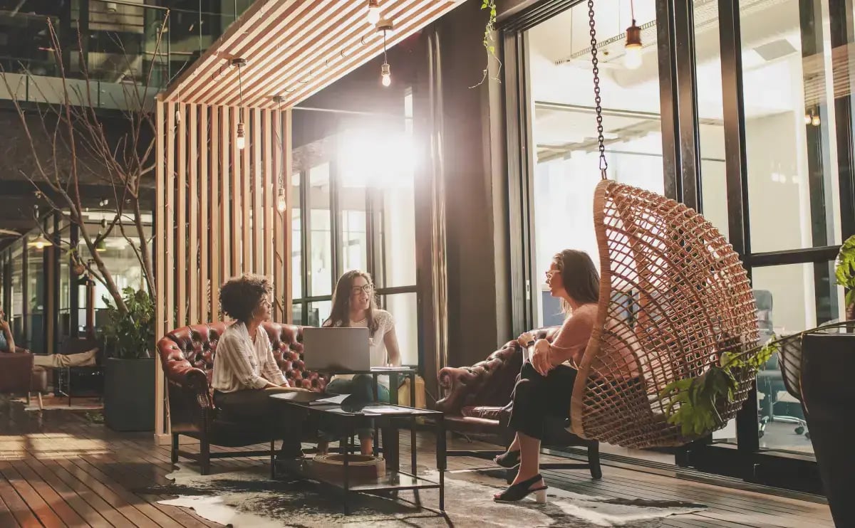 A group of young professionals sitting around a table discussion insurance options.
