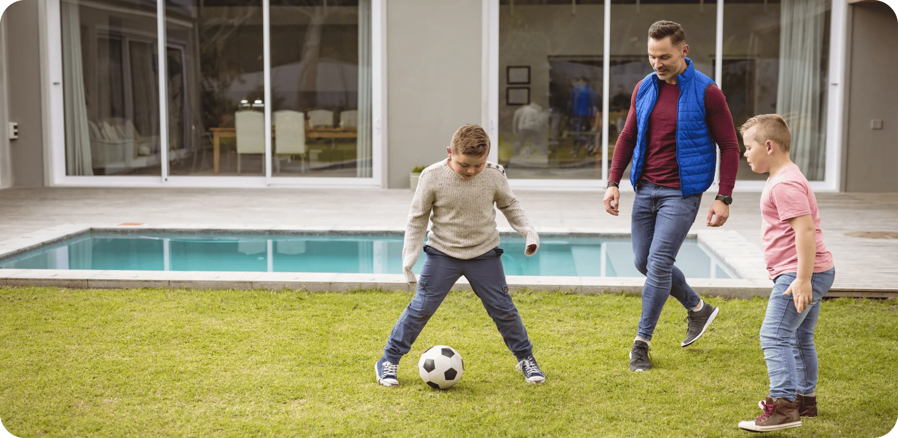 caucasian-father-and-two-sons-playing-football-tog-2023-12-15-05-00-48-utc 1