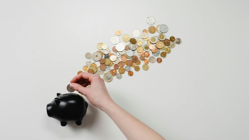 Piggy bank with a trail of coins