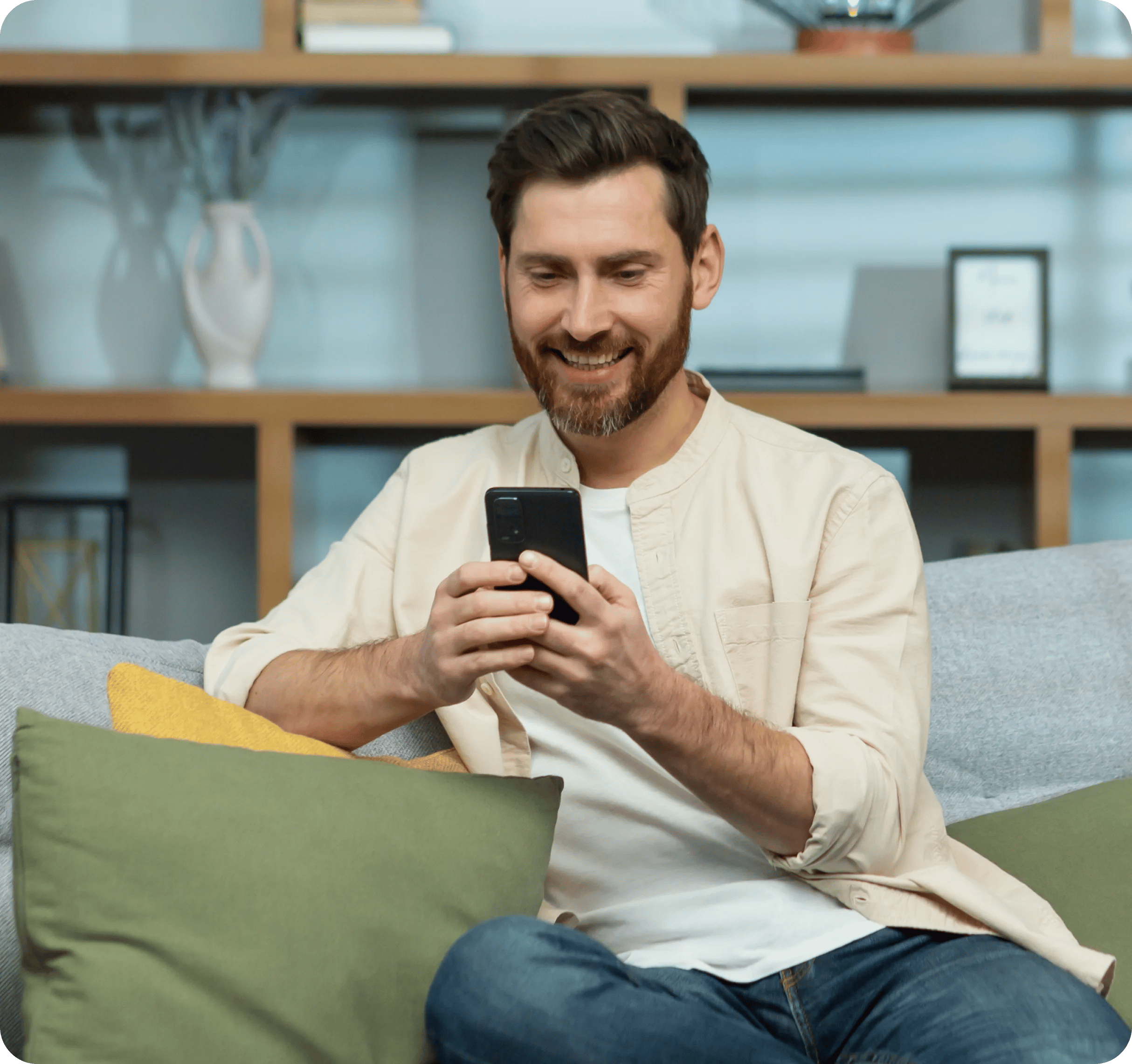 young-smiling-man-sitting-on-sofa-at-home-during-q-2023-11-27-05-03-45-utc 2